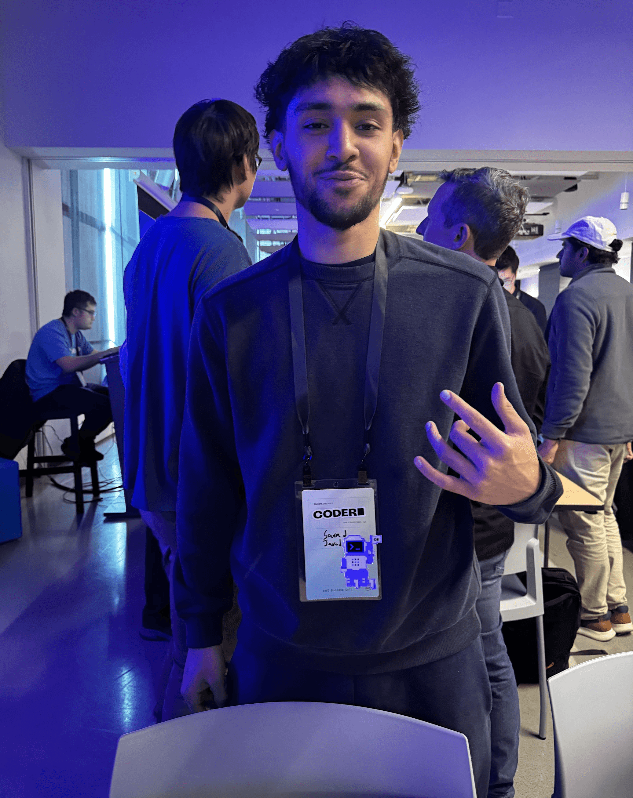 person wearing a lanyard in a room where conference talks take place